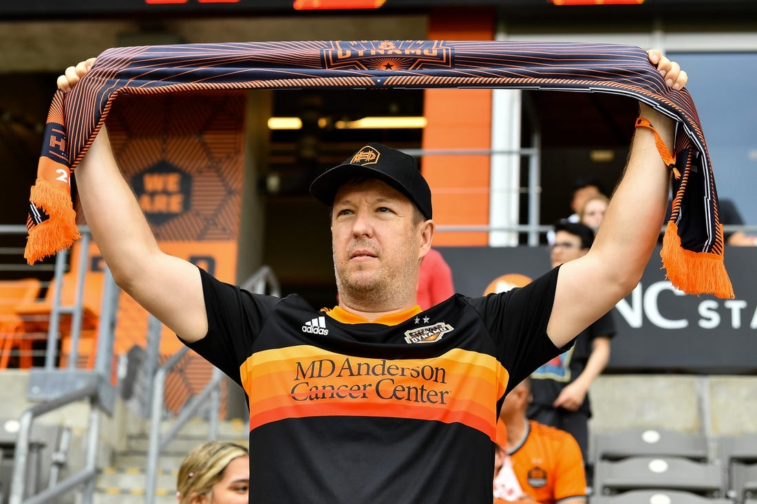 Apr 16, 2022; Houston, Texas, USA;  A fan holds up a scarf in support of the Houston Dynamo FC prior to the match against the Portland Timbers at PNC Stadium. Mandatory Credit: Maria Lysaker-Houston Dynamo-USA TODAY Sports