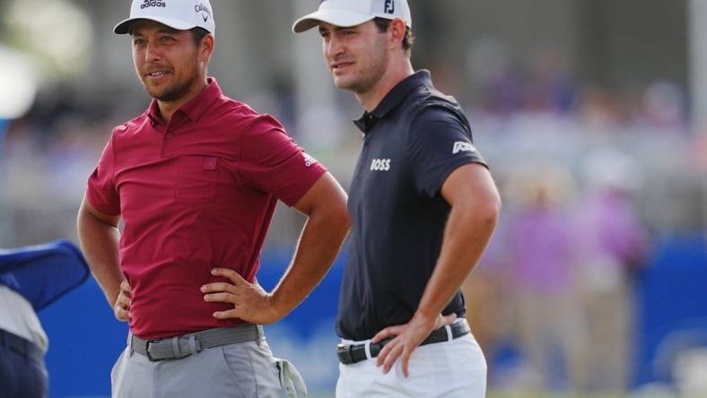 Apr 23, 2022; Avondale, Louisiana, USA; Xander Schauffele and Patrick Cantlay react after playing hole 18 during the third round of the Zurich Classic of New Orleans golf tournament. Mandatory Credit: Andrew Wevers-USA TODAY Sports