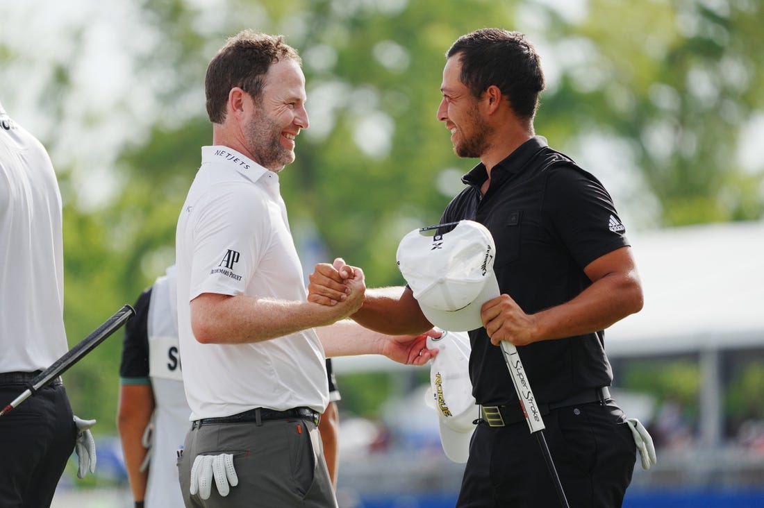 Apr 24, 2022; Avondale, Louisiana, USA; Xander Schauffele (right) embraces Patrick Cantlay (left) on the 18th green during the final round of the Zurich Classic of New Orleans golf tournament. Mandatory Credit: Andrew Wevers-USA TODAY Sports