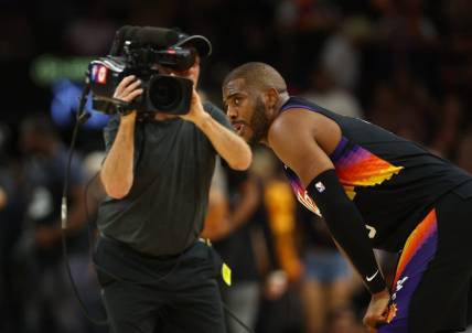 Apr 26, 2022; Phoenix, Arizona, USA; A TV cameraman records Phoenix Suns guard Chris Paul (3) against the New Orleans Pelicans during game five of the first round for the 2022 NBA playoffs at Footprint Center. Mandatory Credit: Mark J. Rebilas-USA TODAY Sports