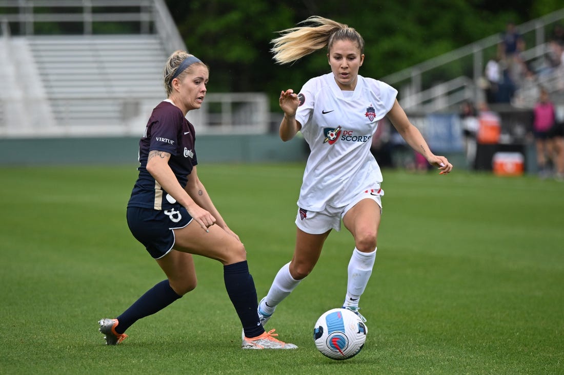 May 7, 2022; Cary, NC, USA;  Washington Spirit midfielder Jordan Baggett (11) moves the ball against North Carolina Courage midfielder Denise O'Sullivan (8) at WakeMed Soccer Park. Mandatory Credit: William Howard-USA TODAY Sports