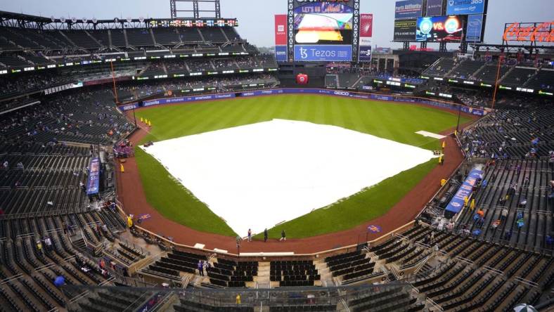 May 14, 2022; New York City, New York, USA; A tarp covers the infield at Citi Field  due to rain before the delayed start of a game between the Seattle Mariners and New York Mets. Mandatory Credit: Gregory Fisher-USA TODAY Sports