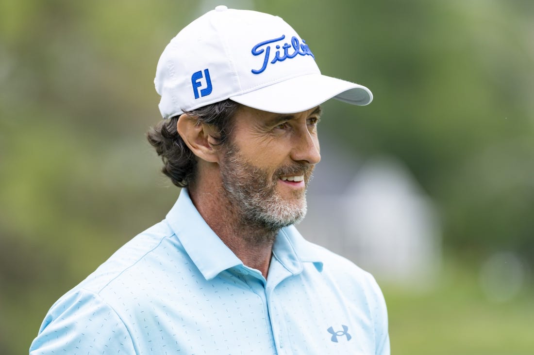 May 26, 2022; Benton Harbor, Michigan, USA; Mark Hensby smiles on the eighteenth green during the first round of the 2022 KitchenAid Senior PGA Championship at Harbor Shores. Mandatory Credit: Raj Mehta-USA TODAY Sports