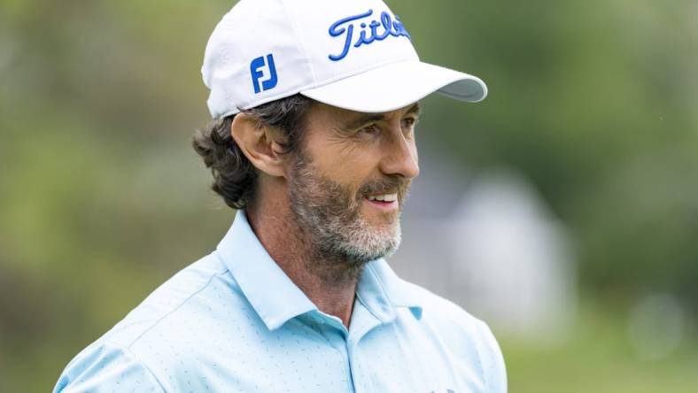 May 26, 2022; Benton Harbor, Michigan, USA; Mark Hensby smiles on the eighteenth green during the first round of the 2022 KitchenAid Senior PGA Championship at Harbor Shores. Mandatory Credit: Raj Mehta-USA TODAY Sports