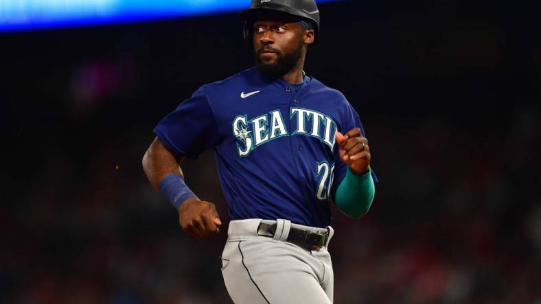 June 25, 2022; Anaheim, California, USA; Seattle Mariners pinch runner Taylor Trammell (20) reaches third against the Los Angeles Angels during the seventh inning at Angel Stadium. Mandatory Credit: Gary A. Vasquez-USA TODAY Sports