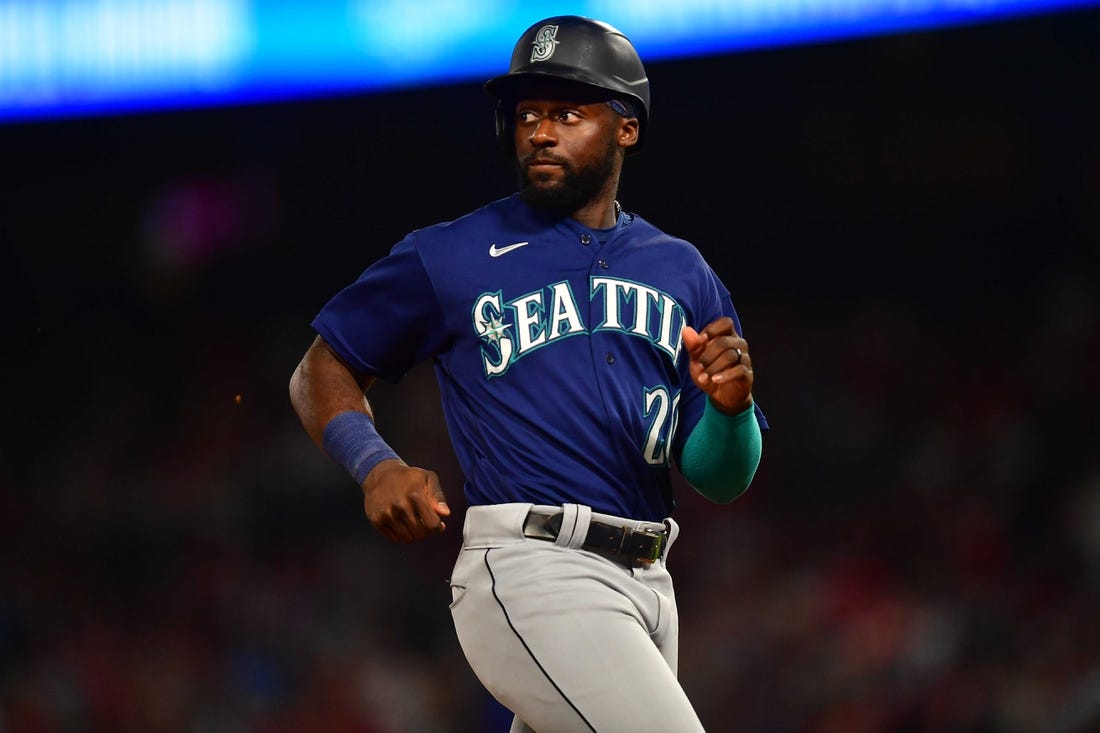 June 25, 2022; Anaheim, California, USA; Seattle Mariners pinch runner Taylor Trammell (20) reaches third against the Los Angeles Angels during the seventh inning at Angel Stadium. Mandatory Credit: Gary A. Vasquez-USA TODAY Sports
