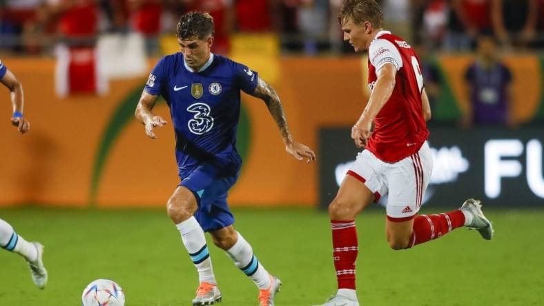 Jul 23, 2022; Orlando, FL, USA; Chelsea forward Christian Pulisic (10) runs with the ball ahead of Arsenal midfielder Martin Odegaard (8) during the second half at Camping World Stadium. Mandatory Credit: Sam Navarro-USA TODAY Sports