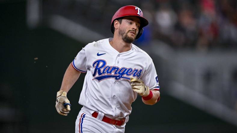 Aug 1, 2022; Arlington, Texas, USA; Texas Rangers pinch hitter Nick Solak (15) rounds the bases after he hits a home run against the Baltimore Orioles during the eighth inning at Globe Life Field. Mandatory Credit: Jerome Miron-USA TODAY Sports