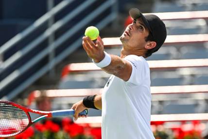 Aug 7, 2022; Montreal, Quebec, Canada; Marcos Giron (USA) serves the ball against Alexei Popyrin (AUS) (not pictured) in second round qualifying play at IGA Stadium. Mandatory Credit: David Kirouac-USA TODAY Sports