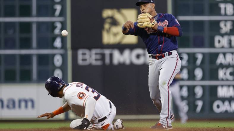 Aug 23, 2022; Houston, Texas, USA; Houston Astros shortstop Jeremy Pena (3) is out at second base as Minnesota Twins second baseman Jorge Polanco (11) throws to first base during the eighth inning at Minute Maid Park. Mandatory Credit: Troy Taormina-USA TODAY Sports