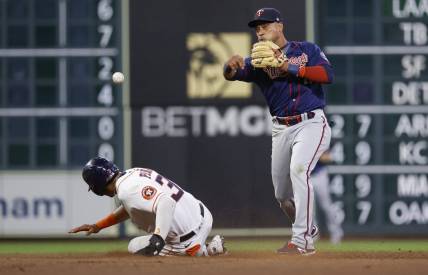 Aug 23, 2022; Houston, Texas, USA; Houston Astros shortstop Jeremy Pena (3) is out at second base as Minnesota Twins second baseman Jorge Polanco (11) throws to first base during the eighth inning at Minute Maid Park. Mandatory Credit: Troy Taormina-USA TODAY Sports
