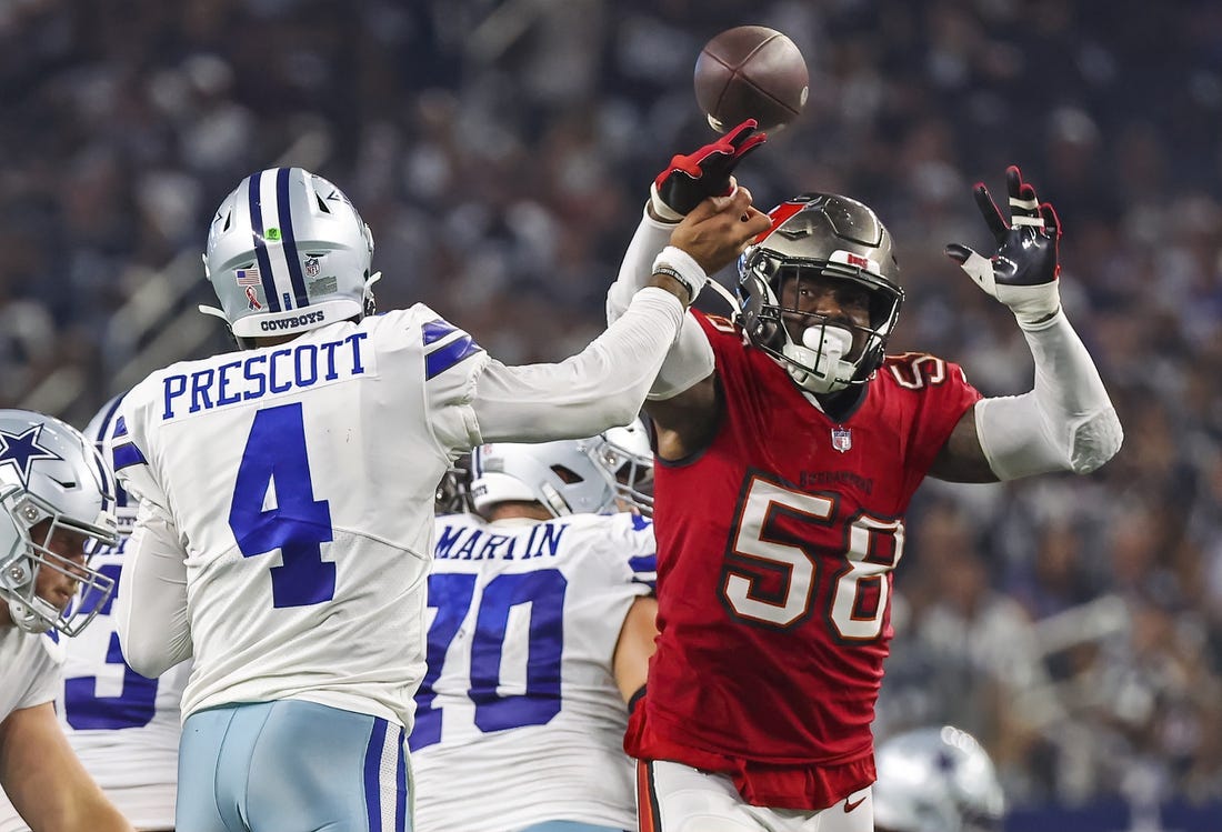 Sep 11, 2022; Arlington, Texas, USA;  Dallas Cowboys quarterback Dak Prescott (4) hits his hand against Tampa Bay Buccaneers linebacker Shaquil Barrett (58) as he throws the ball during the fourth quarter at AT&T Stadium. Mandatory Credit: Kevin Jairaj-USA TODAY Sports