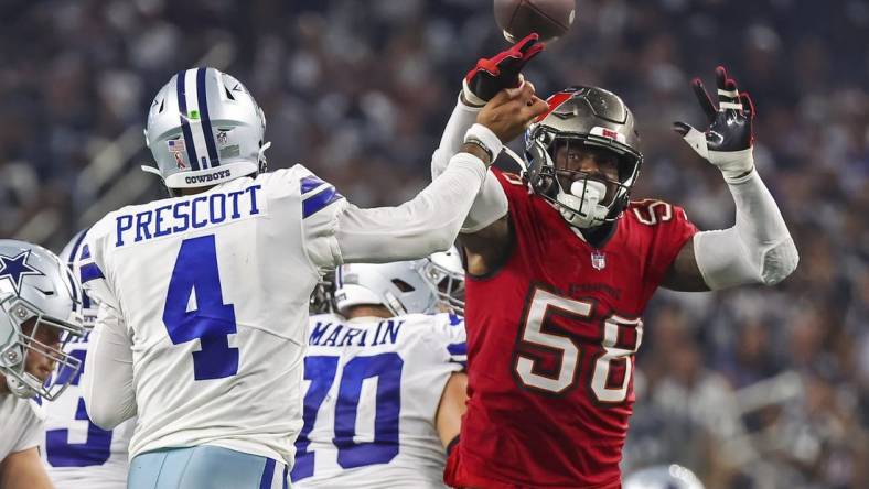 Sep 11, 2022; Arlington, Texas, USA;  Dallas Cowboys quarterback Dak Prescott (4) hits his hand against Tampa Bay Buccaneers linebacker Shaquil Barrett (58) as he throws the ball during the fourth quarter at AT&T Stadium. Mandatory Credit: Kevin Jairaj-USA TODAY Sports