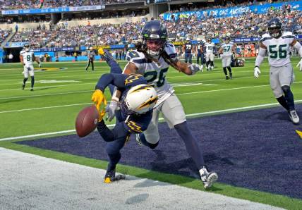 Oct 23, 2022; Inglewood, California, USA;  Seattle Seahawks safety Ryan Neal (26) breaks up a pass for Los Angeles Chargers wide receiver DeAndre Carter (1) in the end zone in the first half at SoFi Stadium. Mandatory Credit: Jayne Kamin-Oncea-USA TODAY Sports