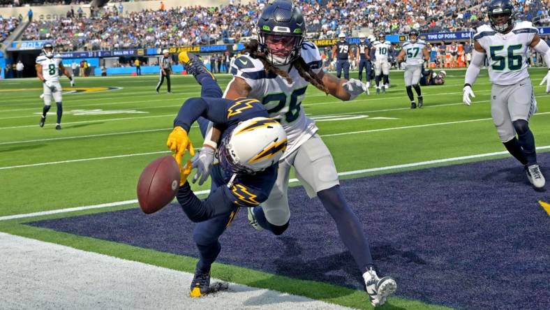 Oct 23, 2022; Inglewood, California, USA;  Seattle Seahawks safety Ryan Neal (26) breaks up a pass for Los Angeles Chargers wide receiver DeAndre Carter (1) in the end zone in the first half at SoFi Stadium. Mandatory Credit: Jayne Kamin-Oncea-USA TODAY Sports