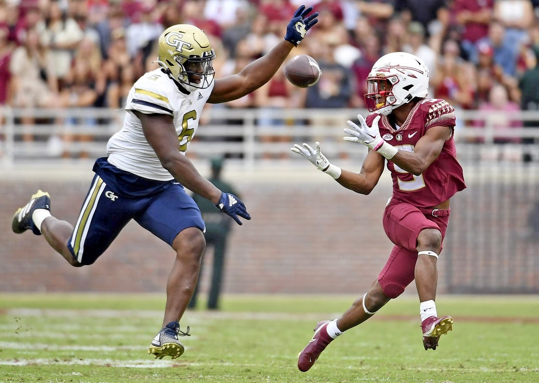 Oct 29, 2022; Tallahassee, Florida, USA; Florida State Seminoles running back Lawrance Toafili (9) catches a pass for a touchdown past Georgia Tech Yellow Jackets defensive lineman Keion White (6) during the game at Doak S. Campbell Stadium. Mandatory Credit: Melina Myers-USA TODAY Sports