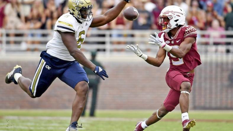 Oct 29, 2022; Tallahassee, Florida, USA; Florida State Seminoles running back Lawrance Toafili (9) catches a pass for a touchdown past Georgia Tech Yellow Jackets defensive lineman Keion White (6) during the game at Doak S. Campbell Stadium. Mandatory Credit: Melina Myers-USA TODAY Sports