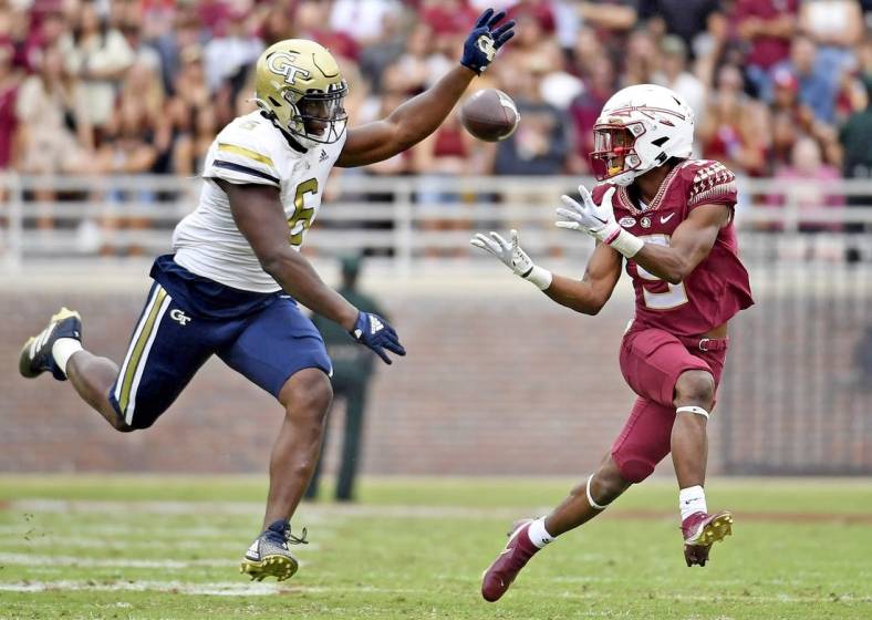 Oct 29, 2022; Tallahassee, Florida, USA; Florida State Seminoles running back Lawrance Toafili (9) catches a pass for a touchdown past Georgia Tech Yellow Jackets defensive lineman Keion White (6) during the game at Doak S. Campbell Stadium. Mandatory Credit: Melina Myers-USA TODAY Sports