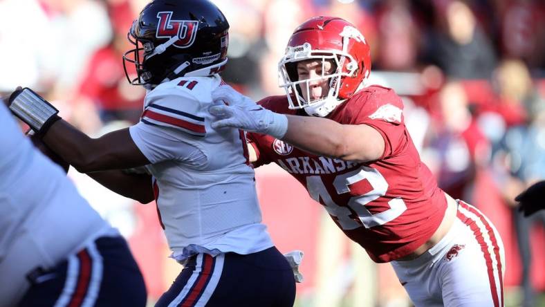 rkansas Razorbacks linebacker Drew Sanders (42) tackles Liberty Flames quarterback Johnathan Bennett (11) in the second quarter at Donald W. Reynolds Razorback Stadium. Mandatory Credit: Nelson Chenault-USA TODAY Sports