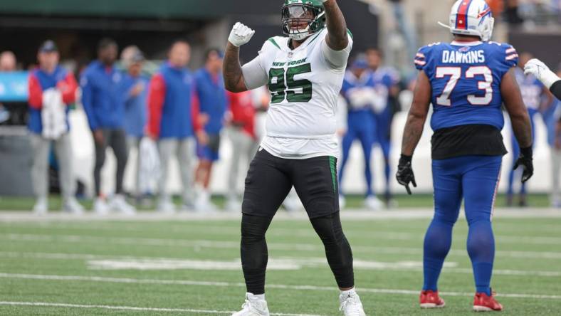 Nov 6, 2022; East Rutherford, New Jersey, USA; New York Jets defensive tackle Quinnen Williams (95) celebrates a defensive stop  being Buffalo Bills offensive tackle Dion Dawkins (73) during the second half at MetLife Stadium. Mandatory Credit: Vincent Carchietta-USA TODAY Sports