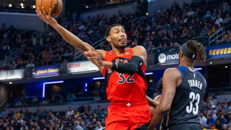 Nov 12, 2022; Indianapolis, Indiana, USA; Toronto Raptors forward Otto Porter Jr. (32) shoots the ball while Indiana Pacers center Myles Turner (33) defends in the first quarter at Gainbridge Fieldhouse. Mandatory Credit: Trevor Ruszkowski-USA TODAY Sports