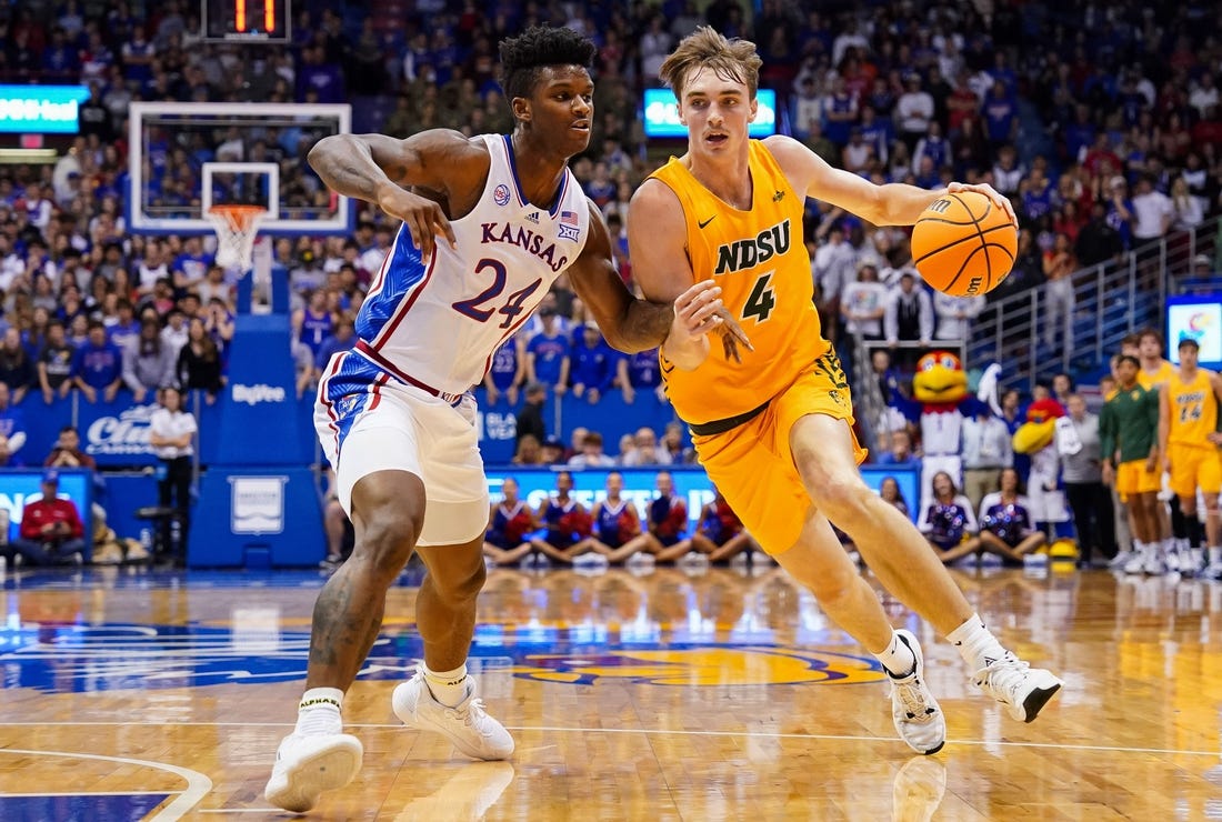 Nov 10, 2022; Lawrence, Kansas, USA; North Dakota State Bison forward Grant Nelson (4) drives against Kansas Jayhawks forward K.J. Adams Jr. (24) during the first half at Allen Fieldhouse. Mandatory Credit: Jay Biggerstaff-USA TODAY Sports