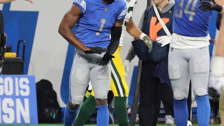 Detroit Lions cornerback Jeff Okudah (1) and linebacker Alex Anzalone (34) celebrate after a stop against the Green Bay Packers during second-half action at Ford Field in Detroit on Sunday, Nov. 6, 2022.

Nfl Green Bay Packers At Detroit Lions