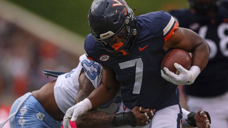 Nov 5, 2022; Charlottesville, Virginia, USA; Virginia Cavaliers running back Mike Hollins (7) carries the ball against the North Carolina Tar Heels during the first half at Scott Stadium. Mandatory Credit: Scott Taetsch-USA TODAY Sports