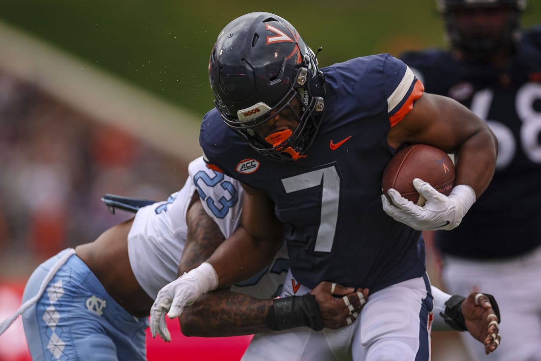 Nov 5, 2022; Charlottesville, Virginia, USA; Virginia Cavaliers running back Mike Hollins (7) carries the ball against the North Carolina Tar Heels during the first half at Scott Stadium. Mandatory Credit: Scott Taetsch-USA TODAY Sports