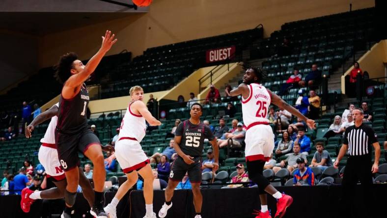 Nov 24, 2022; Orlando, Florida, USA; Oklahoma Sooners guard Grant Sherfield (25) throws a pass to forward Jalen Hill (1) against the Nebraska Cornhuskers during the first half at State Farm Field House. Mandatory Credit: Rich Storry-USA TODAY Sports