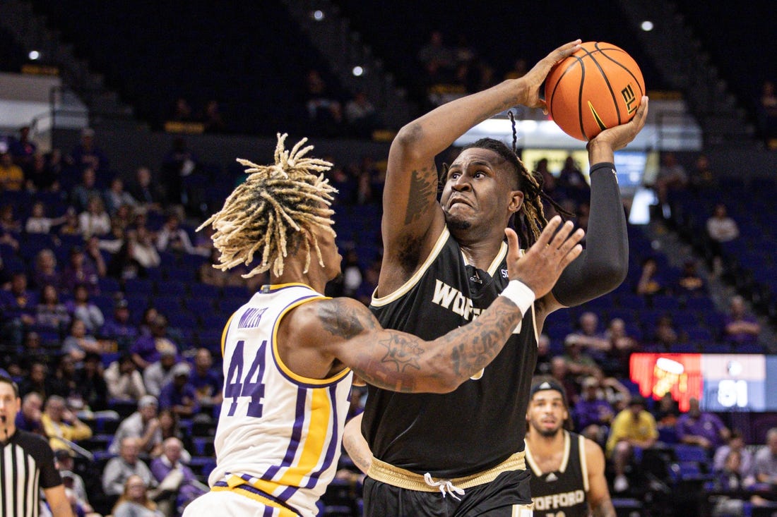 Nov 27, 2022; Baton Rouge, Louisiana, USA; Wofford Terriers forward B.J. Mack (33) drives to the basket against LSU Tigers guard Adam Miller (44) during the second half at Pete Maravich Assembly Center. Mandatory Credit: Stephen Lew-USA TODAY Sports