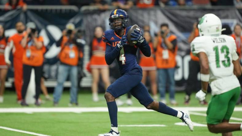 Dec 2, 2022; San Antonio, Texas, USA;  UTSA Roadrunners wide receiver Zakhari Franklin (4) catches a touchdown in the second half against the North Texas Mean Green at the Alamodome. Mandatory Credit: Daniel Dunn-USA TODAY Sports