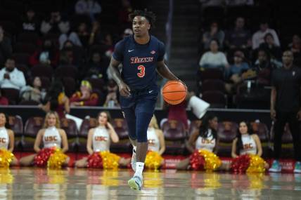 Dec 7, 2022; Los Angeles, California, USA; Cal State Fullerton Titans guard Latrell Wrightsell Jr. (3) dribbles the ball against the Southern California Trojans in the first half at Galen Center. Mandatory Credit: Kirby Lee-USA TODAY Sports