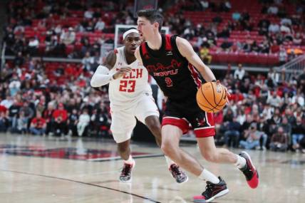 Dec 13, 2022; Lubbock, Texas, USA; Eastern Washington Eagles forward Steele Venters (2) drives to the lane against Texas Tech Red Raiders guard De Vion Harmon (23) in the second half at United Supermarkets Arena. Mandatory Credit: Michael C. Johnson-USA TODAY Sports