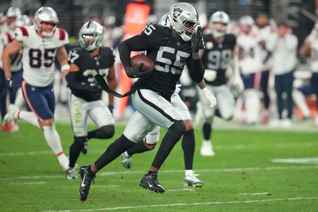 Dec 18, 2022; Paradise, Nevada, USA; Las Vegas Raiders defensive end Chandler Jones (55) returns an interception for a touchdown against the New England Patriots at the end of the second half to give the Raiders a 30-24 victory at Allegiant Stadium. Mandatory Credit: Stephen R. Sylvanie-USA TODAY Sports