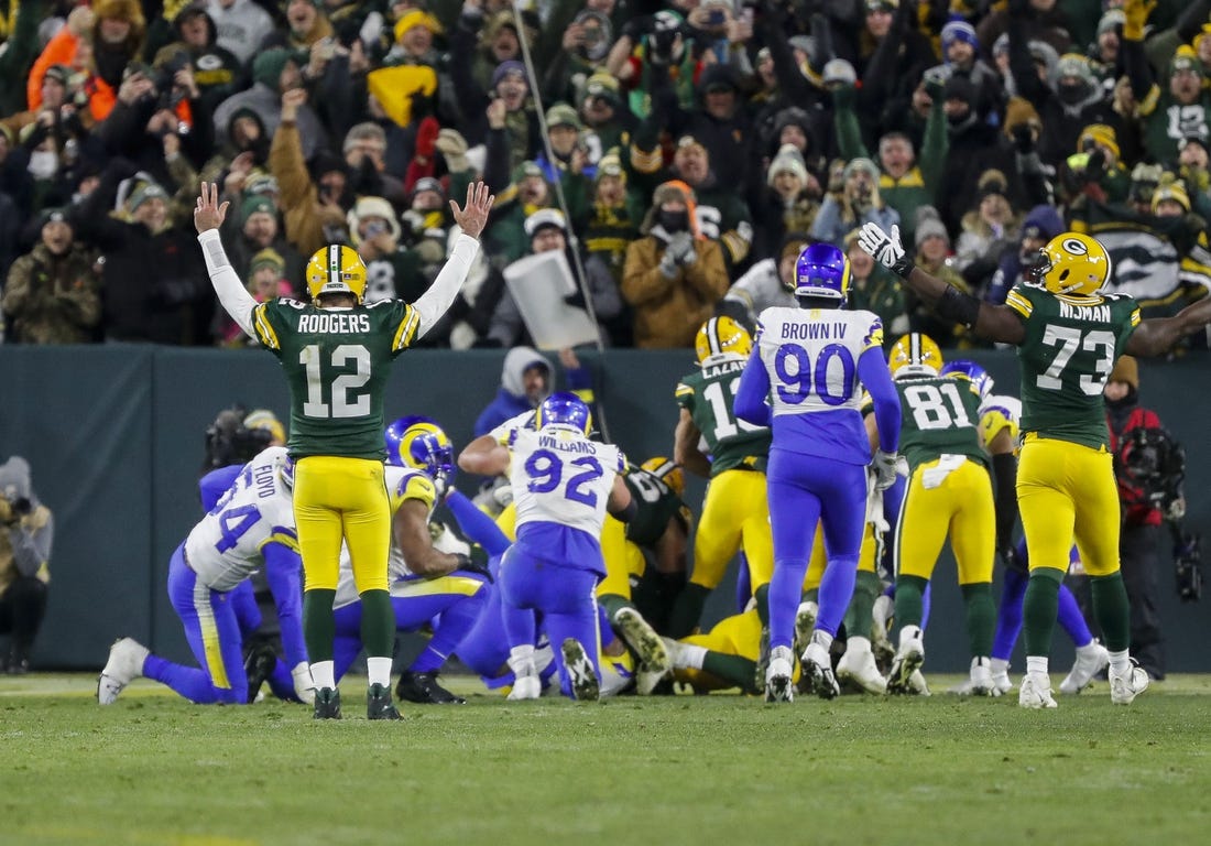 Dec 19, 2022; Green Bay, Wisconsin, USA; Green Bay Packers quarterback Aaron Rodgers (12) reacts as running back AJ Dillon scores a touchdown against the Los Angeles Rams at Lambeau Field. Mandatory Credit: Tork Mason-USA TODAY Sports