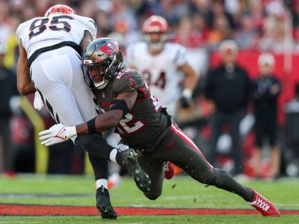 Dec 18, 2022; Tampa, Florida, USA;  Tampa Bay Buccaneers safety Keanu Neal (22) tackles Cincinnati Bengals wide receiver Tee Higgins (85) in the first quarter at Raymond James Stadium. Mandatory Credit: Nathan Ray Seebeck-USA TODAY Sports