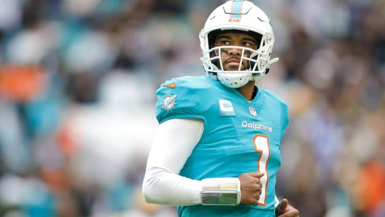 Dec 25, 2022; Miami Gardens, Florida, USA; Miami Dolphins quarterback Tua Tagovailoa (1) looks on from the field during the second quarter against the Green Bay Packers at Hard Rock Stadium. Mandatory Credit: Sam Navarro-USA TODAY Sports