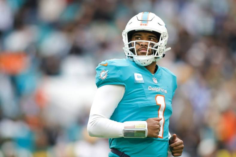 Dec 25, 2022; Miami Gardens, Florida, USA; Miami Dolphins quarterback Tua Tagovailoa (1) looks on from the field during the second quarter against the Green Bay Packers at Hard Rock Stadium. Mandatory Credit: Sam Navarro-USA TODAY Sports
