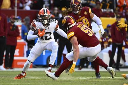 Jan 1, 2023; Landover, Maryland, USA; Cleveland Browns wide receiver Michael Woods II (12) runs after a catch as Washington Commanders linebacker David Mayo (51) defends  during the second half at FedExField. Mandatory Credit: Brad Mills-USA TODAY Sports