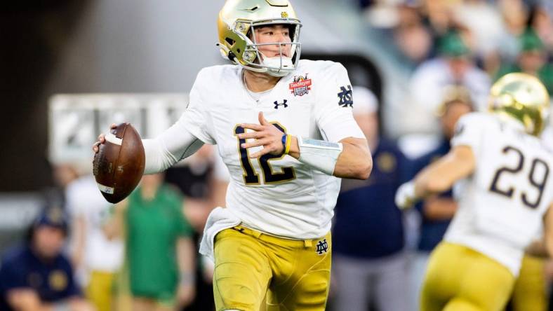 Dec 30, 2022; Jacksonville, FL, USA; Notre Dame Fighting Irish quarterback Tyler Buchner (12) looks to throw during the first half against the South Carolina Gamecocks in the 2022 Gator Bowl at TIAA Bank Field. Mandatory Credit: Matt Pendleton-USA TODAY Sports