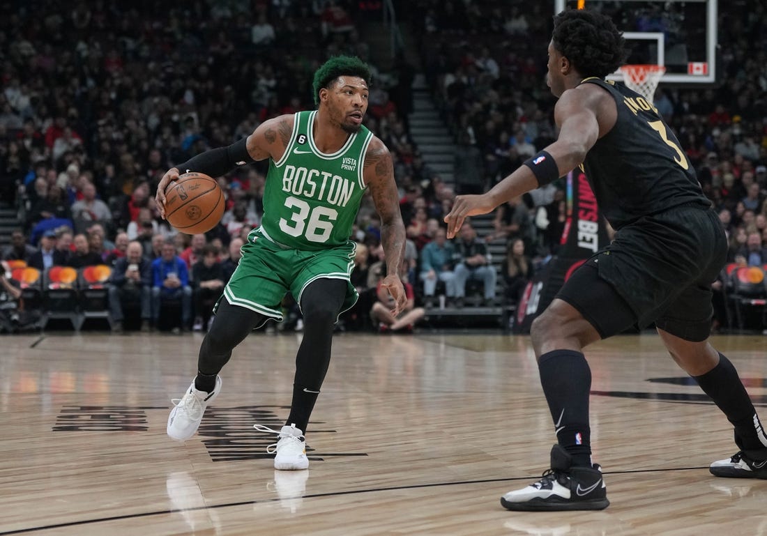 Jan 21, 2023; Toronto, Ontario, CAN; Boston Celtics guard Marcus Smart (36) controls the ball asToronto Raptors forward O.G. Anunoby (3) tries to defend during the first quarter at Scotiabank Arena. Mandatory Credit: Nick Turchiaro-USA TODAY Sports