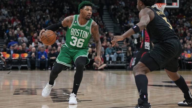 Jan 21, 2023; Toronto, Ontario, CAN; Boston Celtics guard Marcus Smart (36) controls the ball asToronto Raptors forward O.G. Anunoby (3) tries to defend during the first quarter at Scotiabank Arena. Mandatory Credit: Nick Turchiaro-USA TODAY Sports