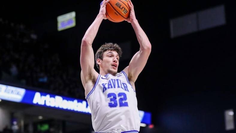 Jan 21, 2023; Cincinnati, Ohio, USA; Xavier Musketeers forward Zach Freemantle (32) grabs the rebound against the Georgetown Hoyas in the first half at Cintas Center. Mandatory Credit: Katie Stratman-USA TODAY Sports