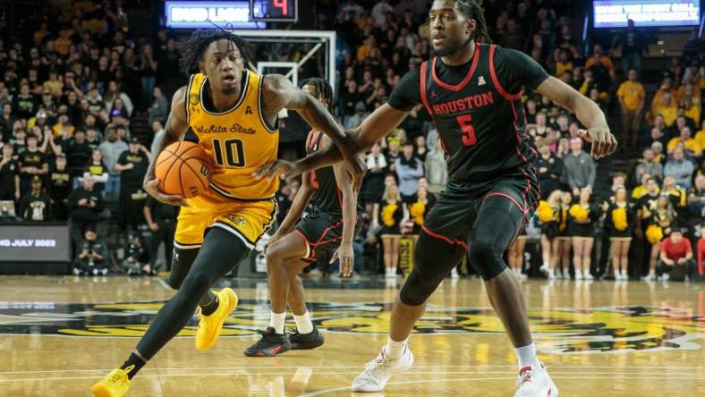 Jan 25, 2023; Wichita, Kansas, USA; Wichita State Shockers guard Jaykwon Walton (10) drives around Houston Cougars forward Ja'Vier Francis (5) during the second half at Charles Koch Arena. Mandatory Credit: William Purnell-USA TODAY Sports