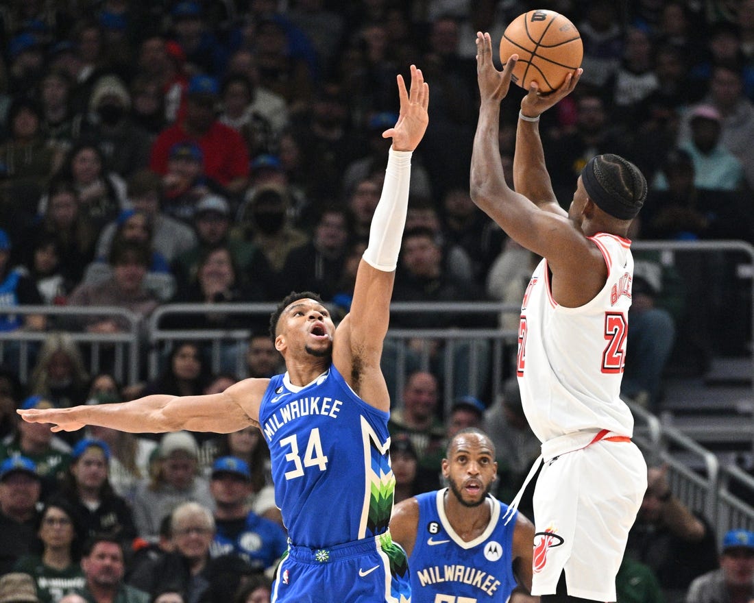 Feb 4, 2023; Milwaukee, Wisconsin, USA; Miami Heat forward Jimmy Butler (22) shoots the ball against Milwaukee Bucks forward Giannis Antetokounmpo (34) in the first half at Fiserv Forum. Mandatory Credit: Michael McLoone-USA TODAY Sports