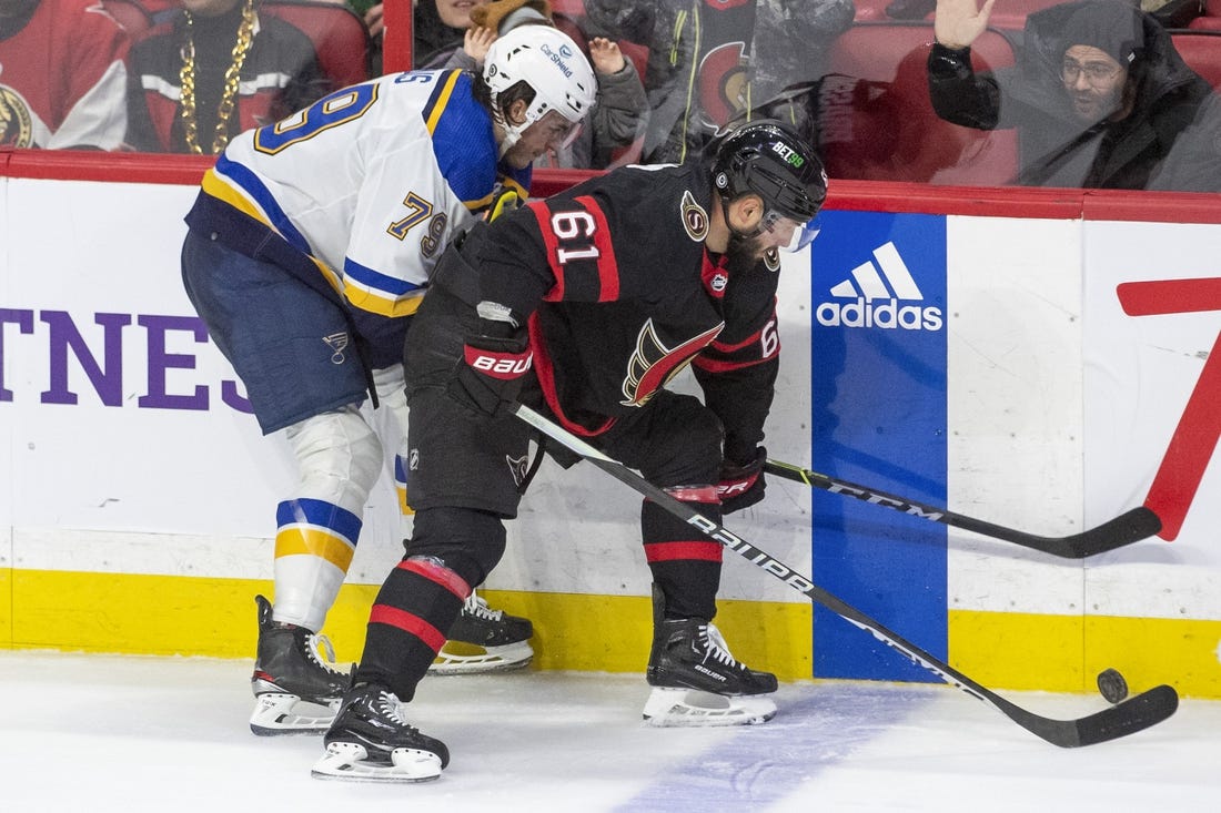 Feb 19, 2023; Ottawa, Ontario, CAN; St. Louis Blues left wing Sammy Blais (79) fights for the puck against Ottawa Senators center Derick Brassard (61) in the third period at the Canadian Tire Centre. Mandatory Credit: Marc DesRosiers-USA TODAY Sports