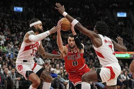 Feb 28, 2023; Toronto, Ontario, CAN; Chicago Bulls guard Zach LaVine (8) tries to get past Toronto Raptors guard Gary Trent Jr. (33) and forward O.G. Anunoby (3) during the second half at Scotiabank Arena. Mandatory Credit: John E. Sokolowski-USA TODAY Sports