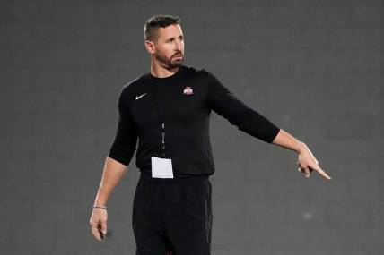 Mar 7, 2023; Columbus, Ohio, USA;  Ohio State Buckeyes offensive coordinator Brian Hartline motions during spring football drills at the Woody Hayes Athletic Center. Mandatory Credit: Adam Cairns-The Columbus Dispatch

Football Ohio State Buckeyes Football