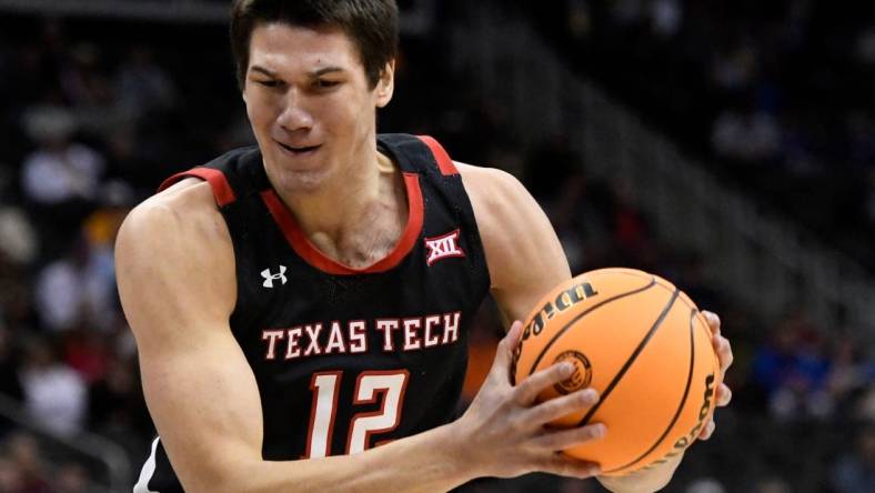 Texas Tech's forward Daniel Batcho (12) rebounds the ball against West Virginia in the first round of the Big 12 basketball tournament, Wednesday, March 8, 2023, at T-Mobile Center in Kansas City.